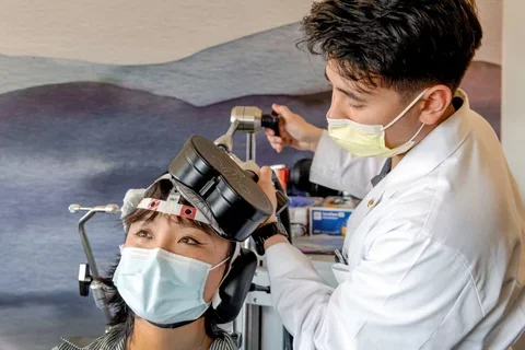 Physician using TMS machine on patient