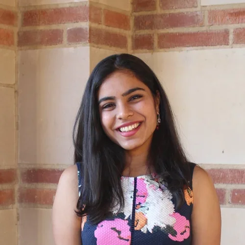 Anouska Saraf standing in the hallways of Royce Hall at UCLA.
