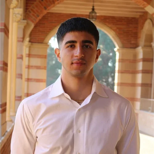 Arno Tatos standing in the hallways of Royce Hall at UCLA.