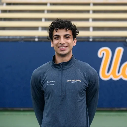 Siddharth Sandu standing on the tennis courts of Los Angeles Tennis Center.