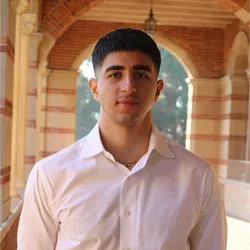 Arno Tatos standing in the hallways of Royce Hall at UCLA.