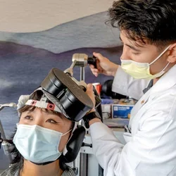 Physician using TMS machine on patient
