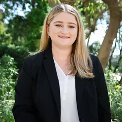 Ashley Hiti standing in the UCLA Botanical Garden. 