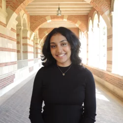 Akshata Kapadne standing in the hallways of Royce Hall at UCLA.